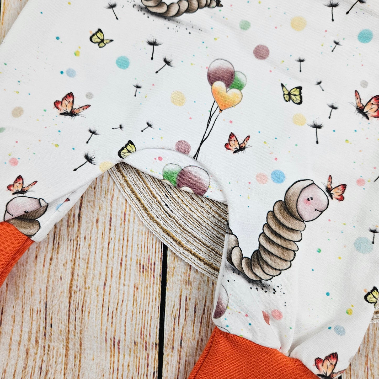 Strampler mit süßen Schmetterlingsraupen und Luftballons